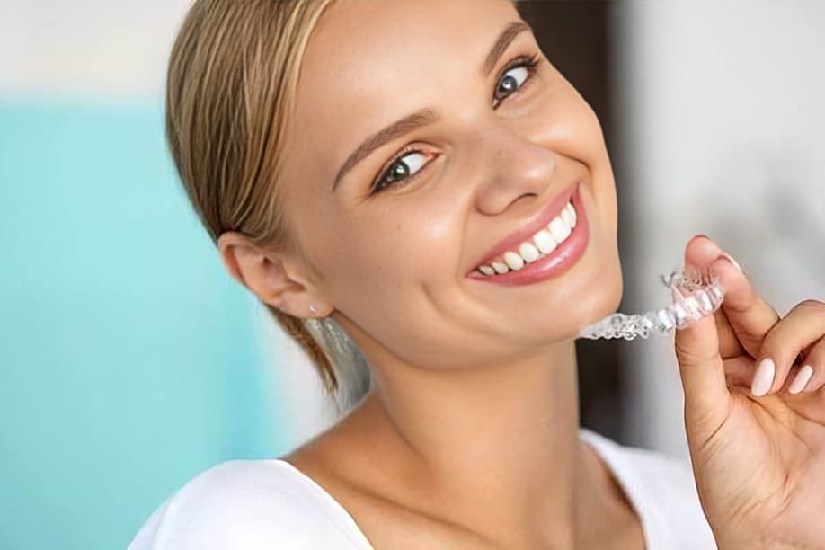 Smiling woman holding dental floss in bright, clean dental office setting promoting oral hygiene.