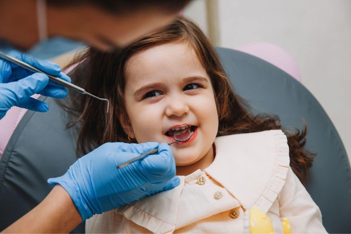 Young patient smiling during dental examination with pediatric dentist in Edinburg, TX.